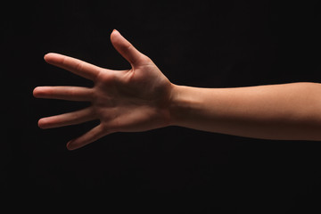 Fototapeta premium Female hand shows number five isolated at black