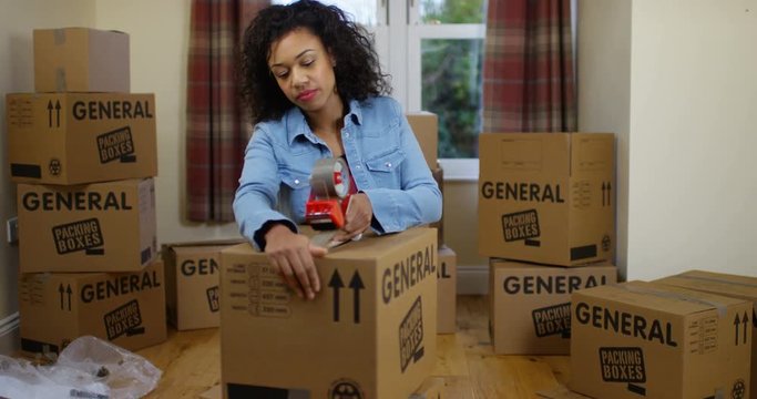 4K Woman packing boxes for house move, staring at camera with fed up expression. Slow motion.