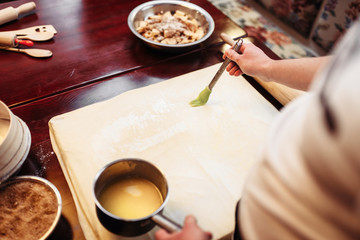 Chef cooking strudel, ingredients on background