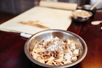 Apple strudel ingredients on wooden table, nobody