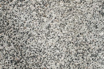 Mixed cement and small stone gravel mosaic slab surface closeup as background