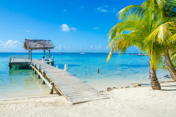 Belize Cayes - Pier on small tropical island at Barrier Reef with paradise beach - known for diving, snorkeling and relaxing vacations - Caribbean Sea, Belize, Central America