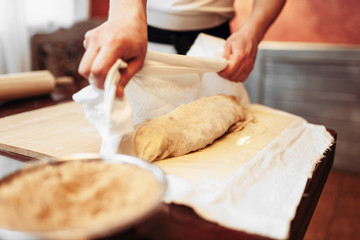 Male chef prepares apple strudel for baking