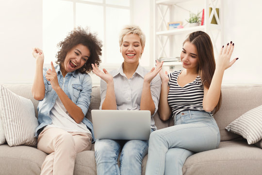 Three beautiful women using laptop at home