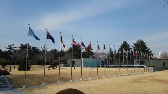 National Flags Waving in the air of UN cemetary in Busan, South Korea, Asia when Feb-22-2018. The UN Memorial Cemetery in Korea honors UN soldiers from 16 countries and UN aids from five countries