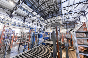Fototapeta premium Factory workshop interior and machines on glass production background