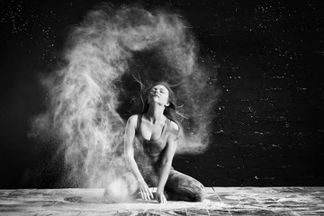 the girl in the flour makes the stroke with the hair, raising a cloud of dust