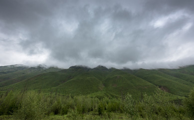 Thick Rain Clouds Over Green Mountains