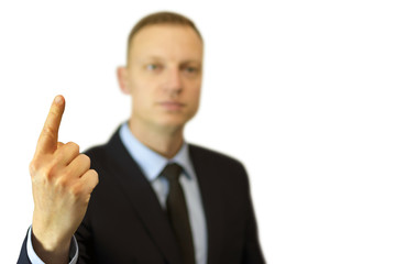 a young and handsome businessman pointing up with his finger