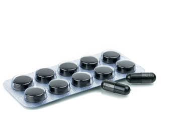 Capsules and tablets pills of activated charcoal in blister pack isolated on white background