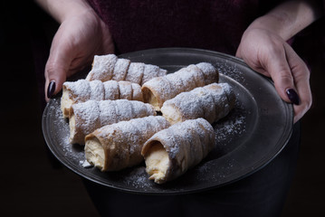 Woman holding stuffed with cream cookies
