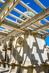 Architectural detail, shadows on the wall. Decorative building detail of the Castle Garden Bazaar (Varkert Bazar) in Budapest, Hungary, blue sky in background.