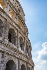 Ancient roman Colosseum detail in Rome, Italy, cloudy sky in background.  Roman Colosseum exterior ruins. Unesco heritage site, Europe. 