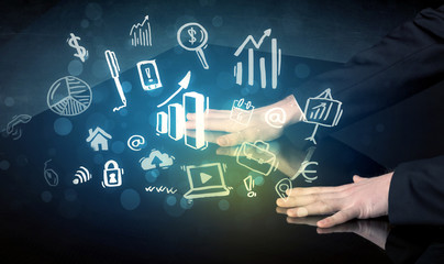 Man touching technology smart table with business icons