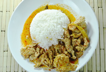 spicy boiled pork in coconut milk curry eat couple with rice on plate
