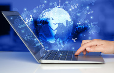 Hand using laptop with worldwide reports links and statistics concept