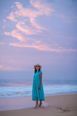 Woman at the seashore of Indian ocean after sunset