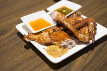roasted chicken legs with sauce, style thai food.