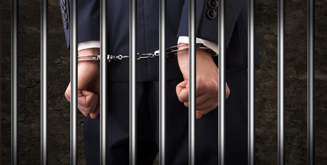 Close handcuffed man in jail