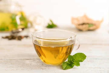 Glass cup of aromatic tea on table