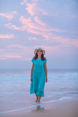 Woman at the seashore of Indian ocean after sunset
