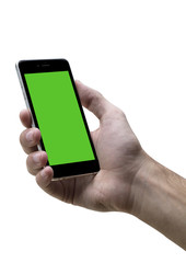 Male hand holding black cellphone with green screen at isolated white background.
