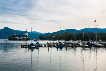 Marina with sailing boats and Church on the lake Traunsee in the Austrian Alps, Austria