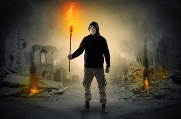 Man coming with burning flambeau at a catastrophe scene concept