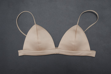 triangular beige silk bra isolated on black, bralette