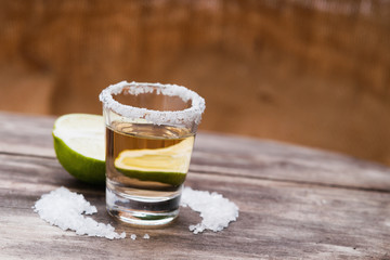 Tequila shot with lime fruit and salt 