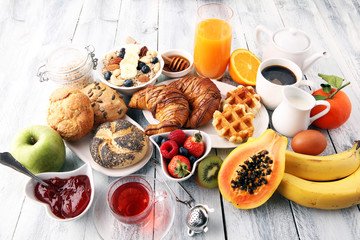 Breakfast served with coffee, orange juice, croissants and fruits. Balanced diet.