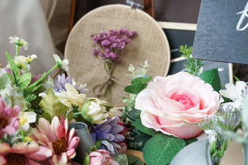 Fake flower. Artificial flowers for home decor or wedding reception decoration with selective focus on the pink rose. Vintage.