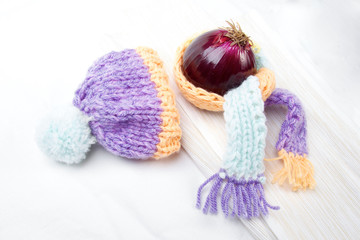 Fototapeta premium Concept of flu sick person with cap and scarf with healthy tea, fruit and vegetable
