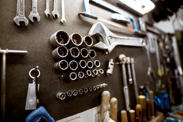 Workshop tool holder with a wrench and set of wrench sockets.