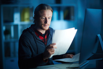 Buisnessman working with documents at his office table till night