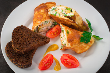 Homemade French omelette with cottage cheese, herbs and tomatoes. Old black rustic background. Top view