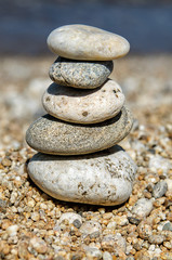 Fototapeta na wymiar pyramid of colorful pebbles . Rock Zen in the background of the sea. Concept of harmony and balance.