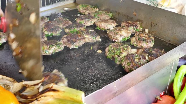 Fresh lamb kebabas on a flattop grill (Plancha) - Street food in the making 