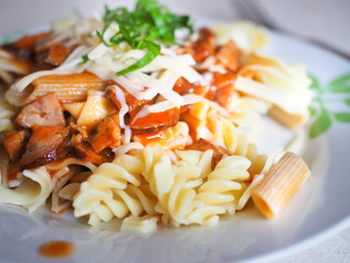 pasta with meat, cheese, tomato sauce and basil.