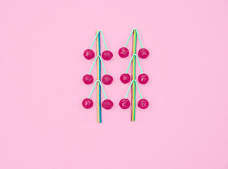 Assorted colored lollipops on pink background.