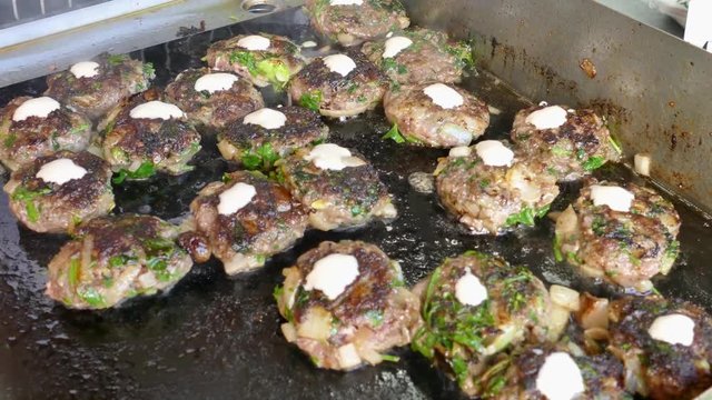 Fresh lamb kebabas on a flattop grill (Plancha) - Street food in the making 