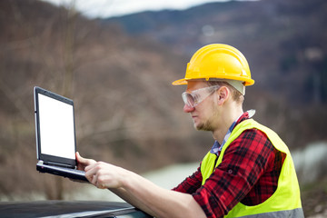 Industrial worker using laptop