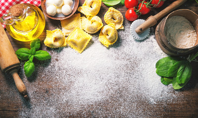Top view on homemade pasta ravioli on old wooden table
