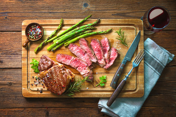 Roasted rib eye steak with green asparagus and wine - obrazy, fototapety, plakaty