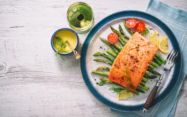 Fotobehang Grilled salmon garnished with green asparagus and tomatoes © Alexander Raths