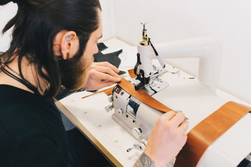 Professional Leather Worker working with leatherwork at his workplace