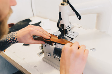 Professional Leather Worker working with leatherwork at his workplace