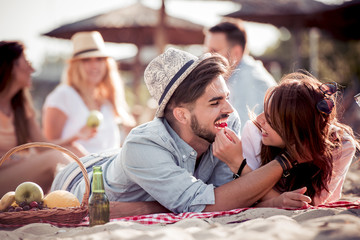 Happy young people having fun on the beach on a summer day.