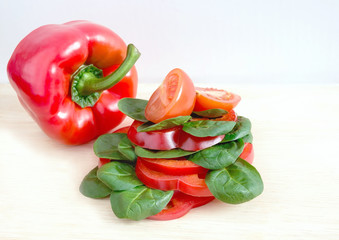 sandwich with vegetables, pepper, tomato, lettuce on a light background