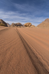 Long car trail to the mushroom rock in Wadi Rum desert, Jordan